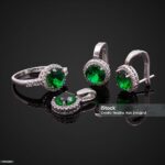 Set of rings, earrings and pendants on black background.